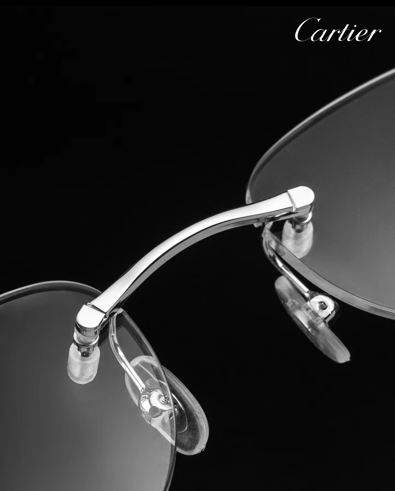 City Specs 2026 Cartier CT0058O 003 silver rimless glasses resting on black case at City Specs