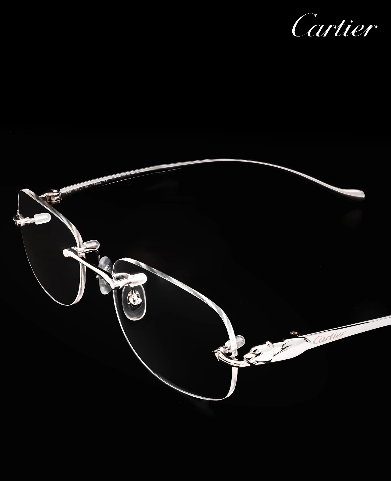 City Specs 2026 Cartier CT0058O 003 silver rimless glasses resting on black case at City Specs