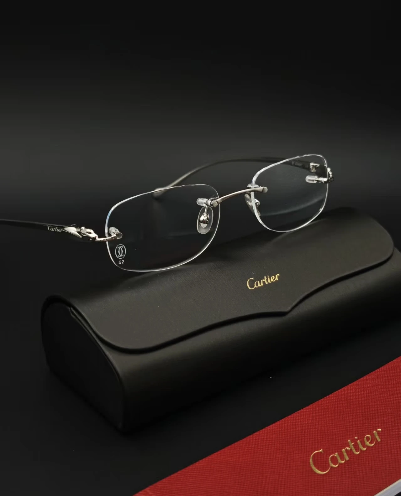 City Specs 2026 Cartier CT0058O 003 silver rimless glasses resting on black case at City Specs