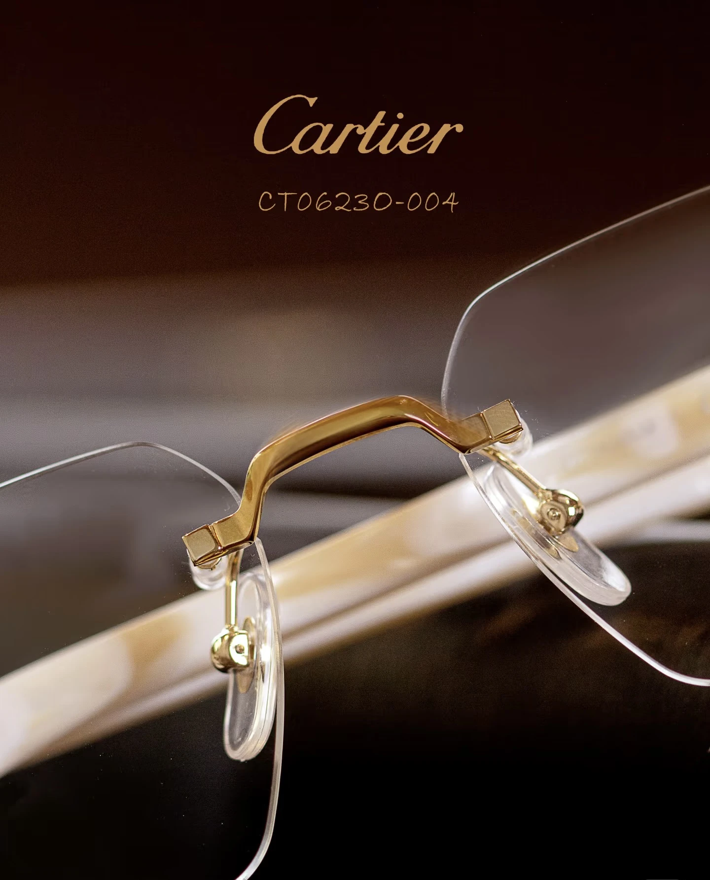 City Specs 2026 View of Cartier CT0623O 004 gold and white rimless glasses on brown case at City Specs opticians
