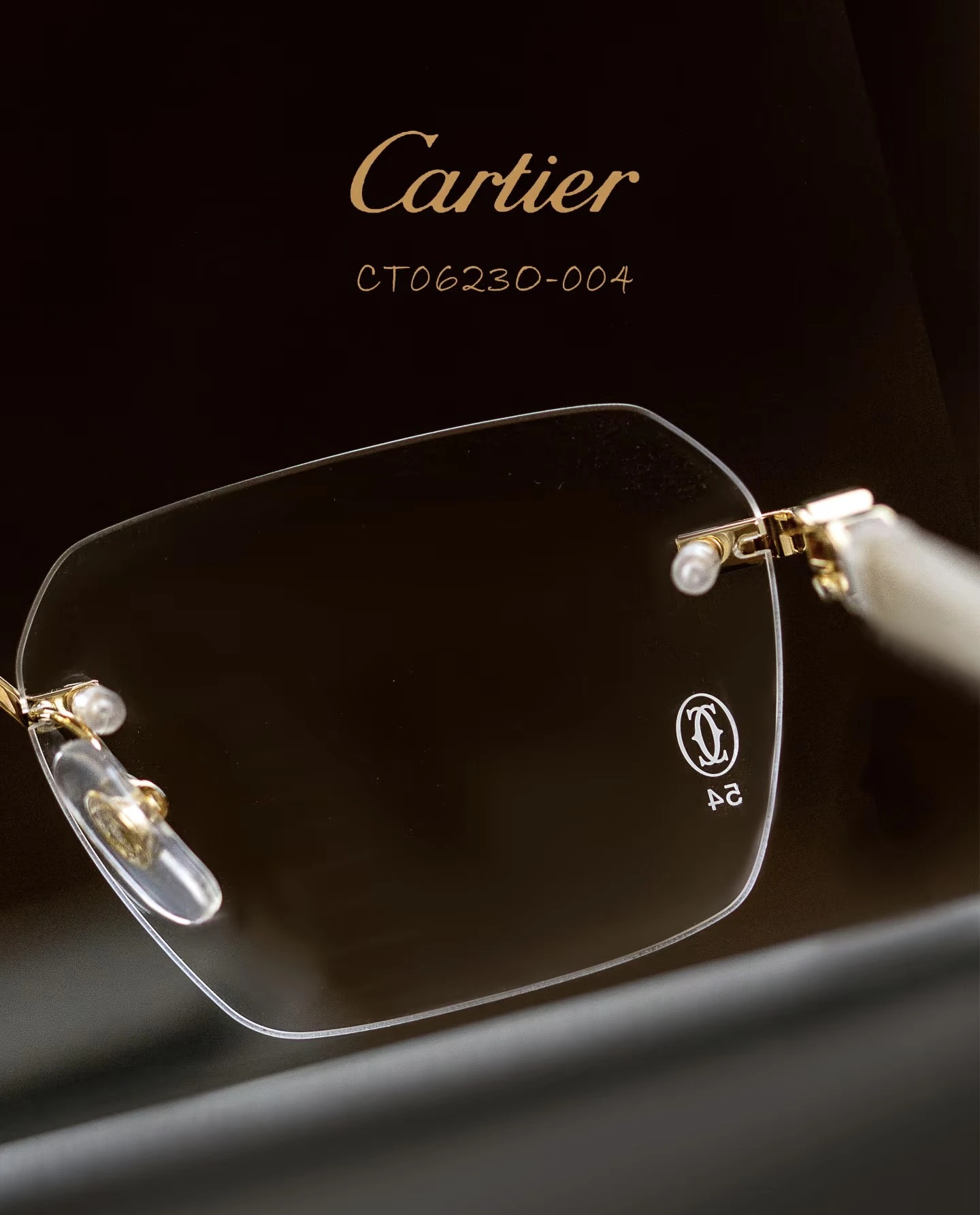 City Specs 2026 View of Cartier CT0623O 004 gold and white rimless glasses on brown case at City Specs opticians
